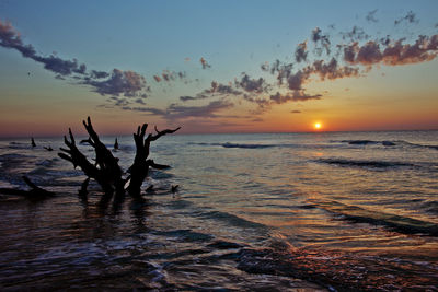 Scenic view of sea against sky at sunset