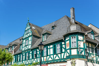 Low angle view of building against clear blue sky