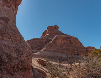 Full frame view of sandstone formations against a clear blue sky