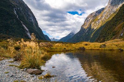 Scenic view of lake and mountains against sky