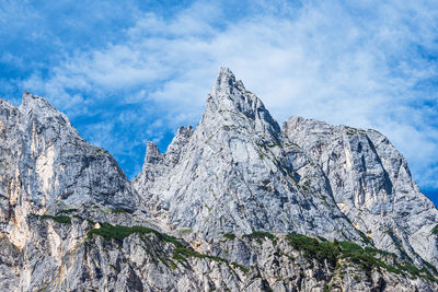 Low angle view of rocky mountains against sky