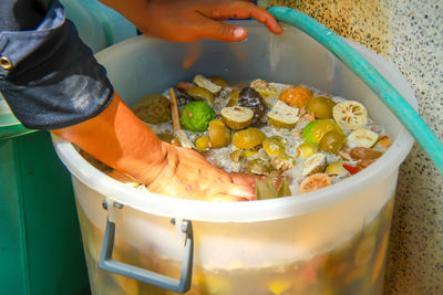 Person preparing food, vegetables and fruits in the fermentation tank made bio-fermented water.