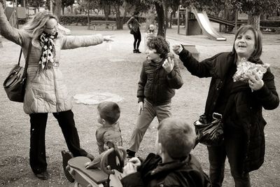 Mothers with playful children at park