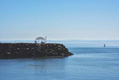 Scenic view of sea against clear blue sky