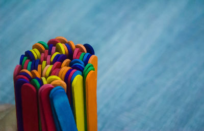 High angle view of colorful popsicle sticks on wooden table