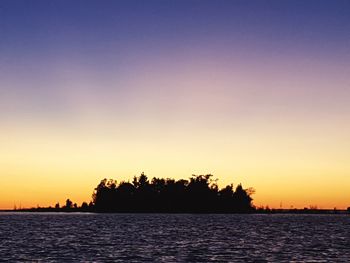 Scenic view of sea against clear sky during sunset