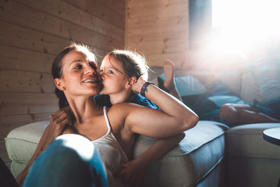 Young woman sitting on sofa at home