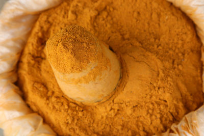 Close-up of ground turmeric for sale in market
