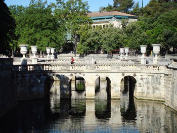 Arch bridge over river in city