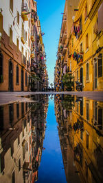 Reflection of buildings in puddle