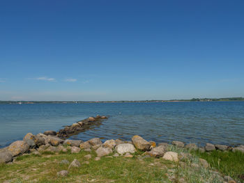 Scenic view of sea against blue sky