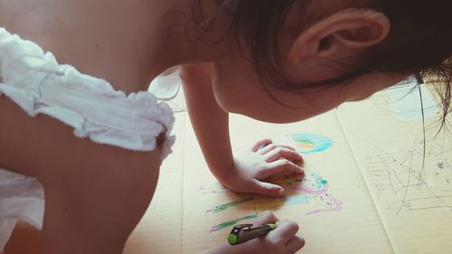 Close-up of hands holding girl at home