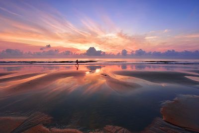 Scenic view of beach against sky during sunset
