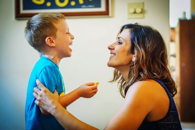 Young woman laughing with boy