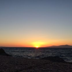 Scenic view of sea against clear sky during sunset