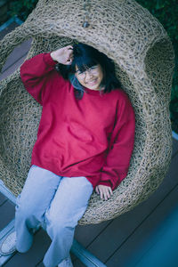 High angle portrait of girl sitting in hanging chair