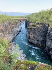 Scenic view of waterfall against sky