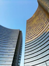 Low angle view of skyscraper against clear blue sky