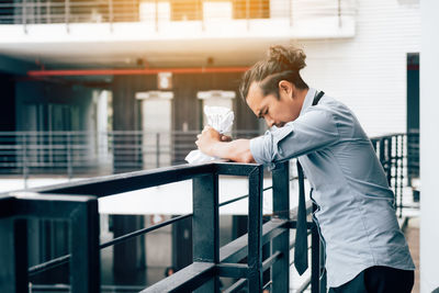 Side view of man standing in balcony