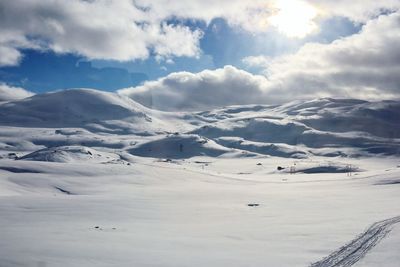 Scenic view of snow covered mountains against sky