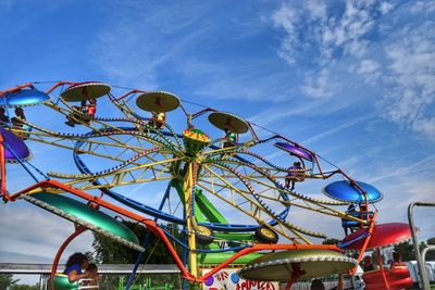 People enjoying ferries wheel ride at amusement park