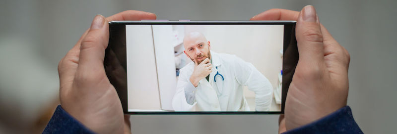 Midsection of man using mobile phone