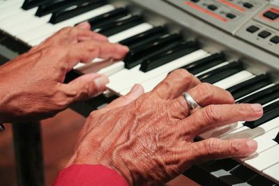 Midsection of man playing piano