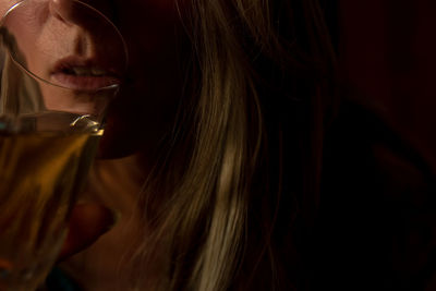 Close-up of young woman drinking glass