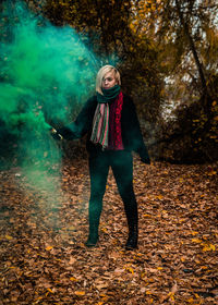 Full length portrait of a teenage girl standing in autumn