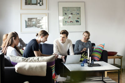 Family sitting in living room of new home