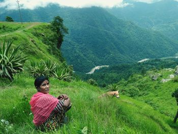 Portrait of woman sitting on mountain