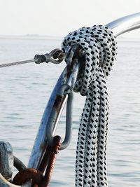 Close-up of sailboat in sea against sky