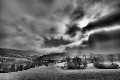 Scenic view of landscape against sky during winter