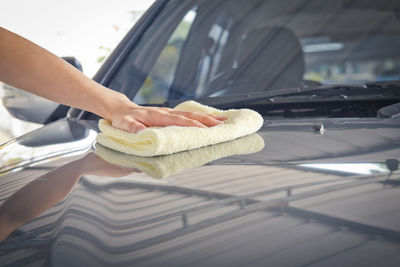 A wipe clean the car with cloth and polishing waxing cream,vintage tone