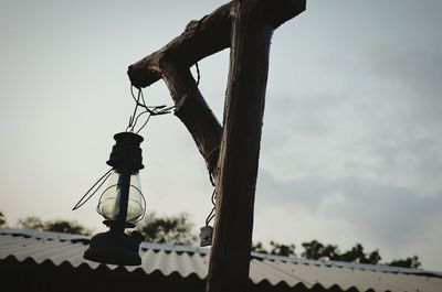 Low angle view of chain hanging against sky