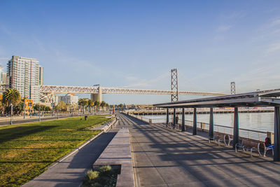 Bridge in city against clear sky