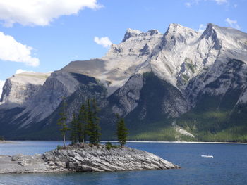 Scenic view of sea and mountains against sky