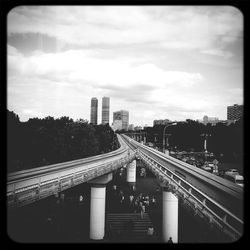 Railroad tracks against cloudy sky