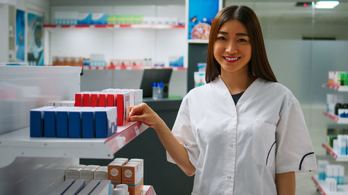 Portrait of young woman standing in laboratory