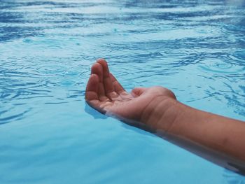 Close-up of hands in swimming pool