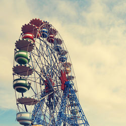 Low angle view of ferris wheel against sky