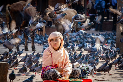 Full length of woman sitting at market