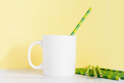 Close-up of drink on table against wall