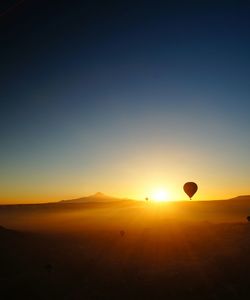 Hot air balloons against sky at sunrise