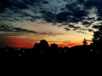 Silhouette trees against sky during sunset