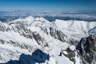 Scenic view of snowcapped mountains against sky during winter