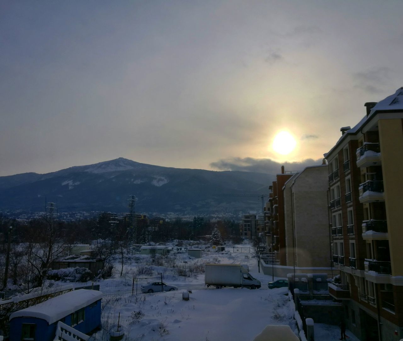 SNOWCAPPED MOUNTAINS AGAINST SKY DURING SUNSET