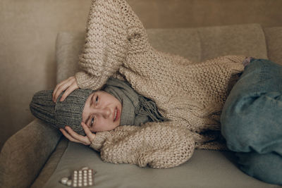 Portrait of woman sitting on sofa at home