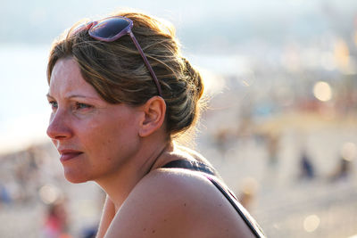 Close-up portrait of young woman looking away