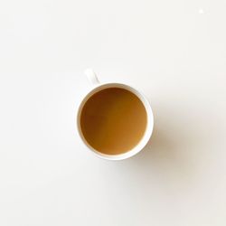 High angle view of coffee cup against white background